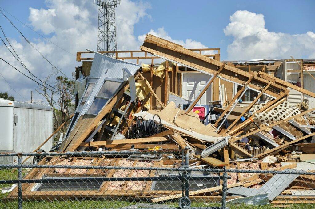 Badly damaged mobile home after hurricane Ian in Florida residential area.