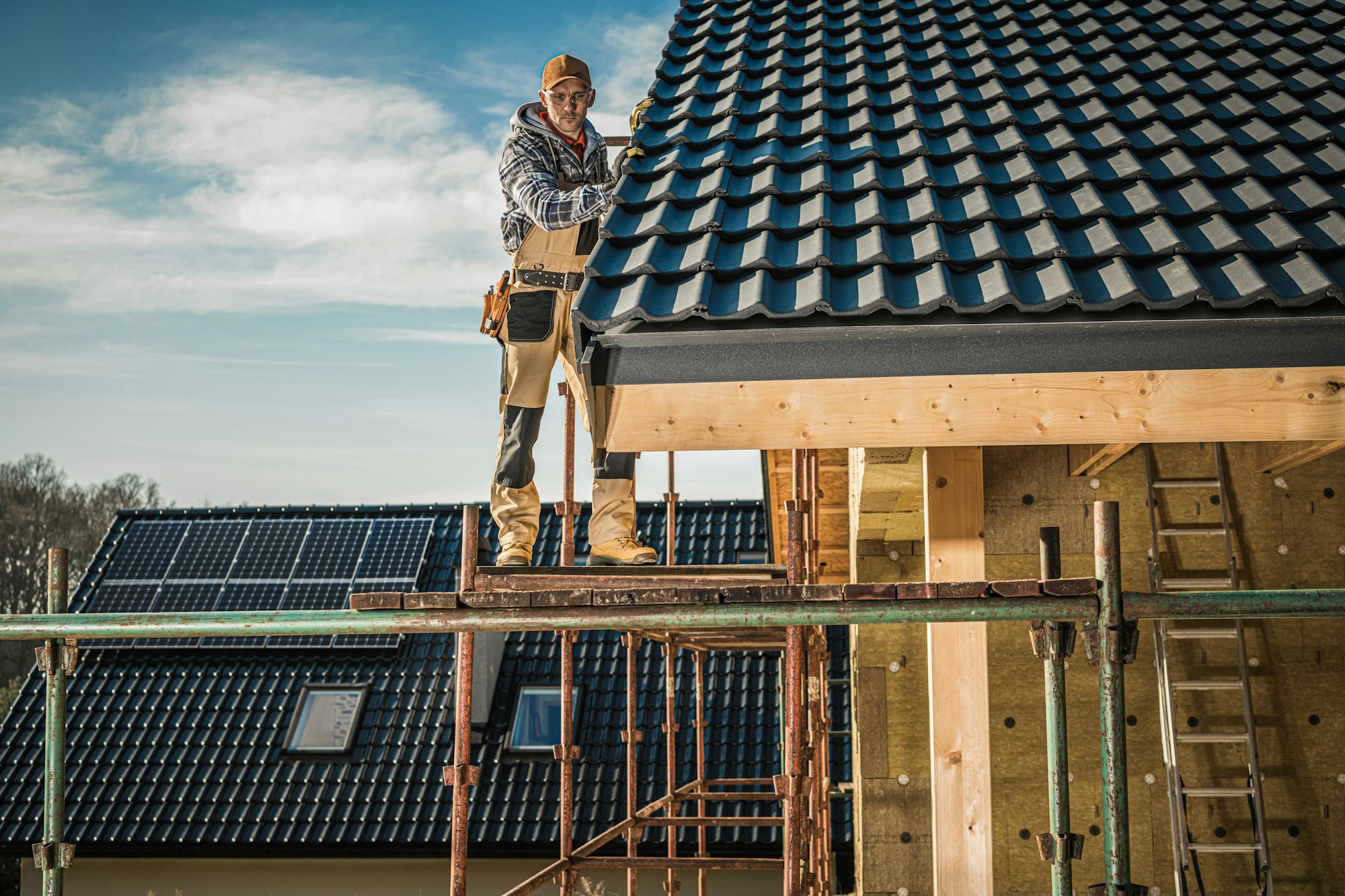 Construction Worker Performing Roof Installation